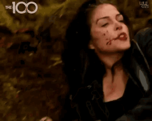 a close up of a woman 's face with blood coming out of it .