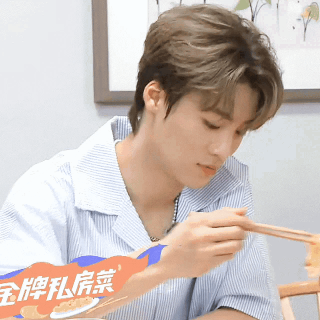 a man eating with chopsticks and a sign that says ' chinese food ' on it