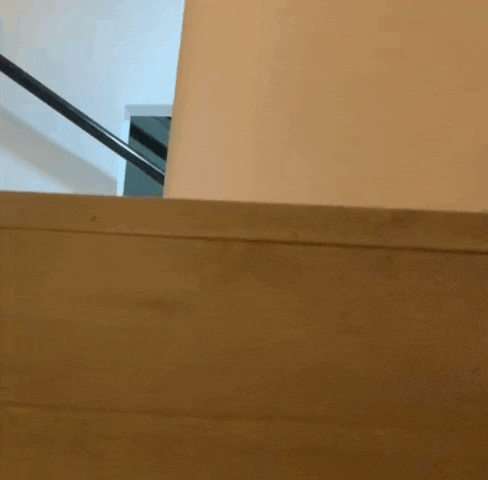 a person is walking down a set of stairs with blood on the wall