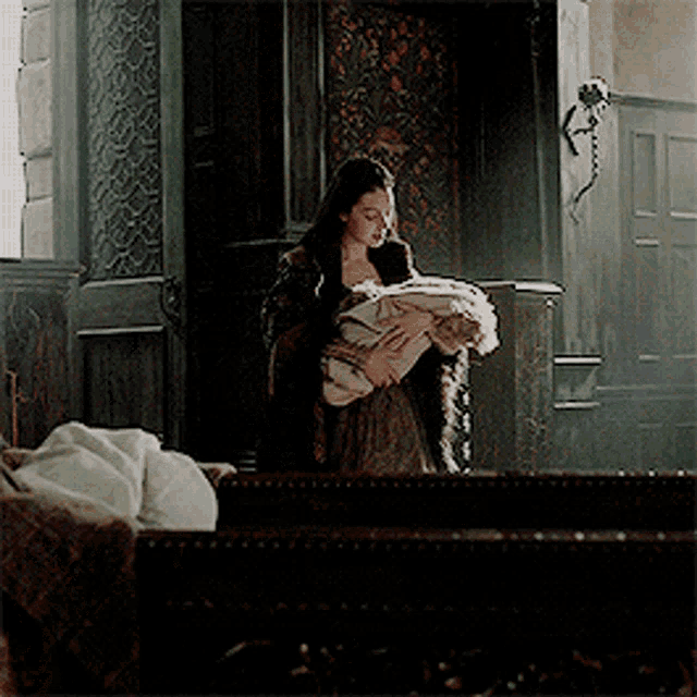 a woman holding a baby in her arms in a church