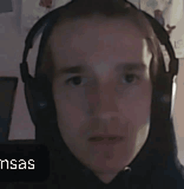 a close up of a man wearing headphones with the word kansas in the background