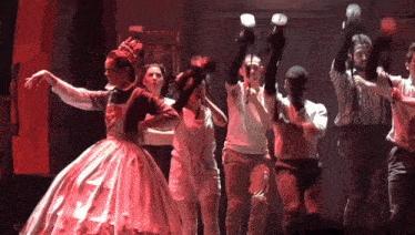 a group of people are dancing in front of a building that says building