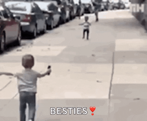 a little boy is running down a street with the words besties written in the corner