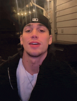 a man wearing a black hat with the letter p on the front