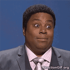 a man in a suit and tie making a funny face
