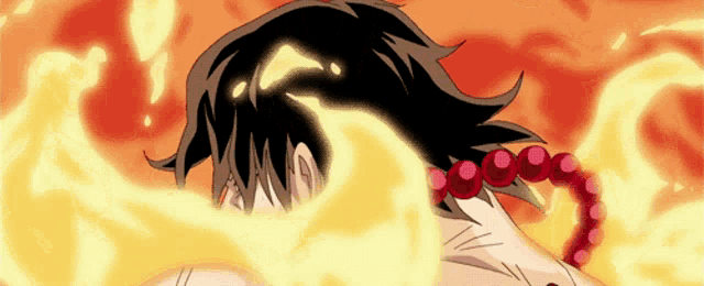 a person with a necklace of red beads is surrounded by fire