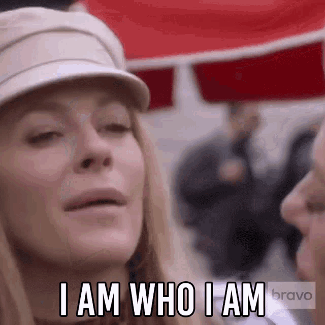 a woman is wearing a hat and says i am who i am