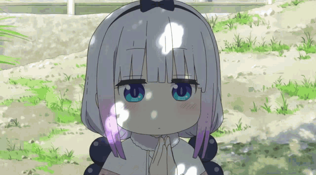 a girl with a bow on her head has blue eyes