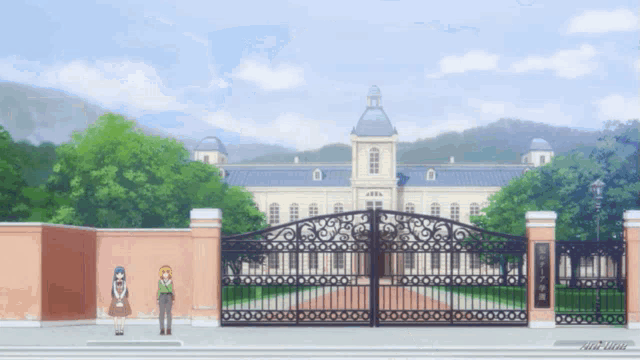 a couple of people standing in front of a building with a gate
