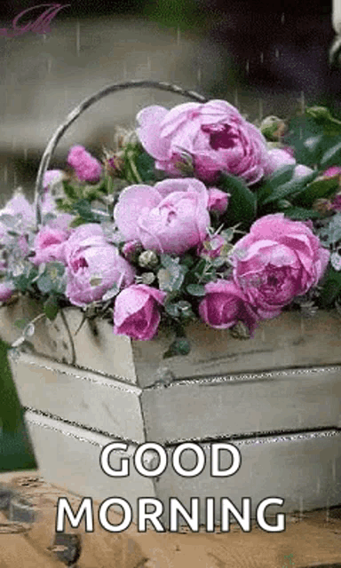 a basket filled with pink flowers and the words `` good morning ''
