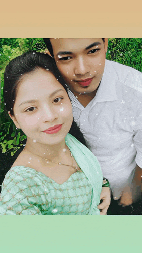 a man and a woman posing for a picture with snow falling on their faces