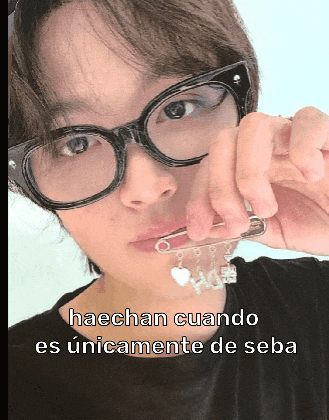 a woman wearing glasses and a black shirt with the words haechan cuando es unicamente de seba
