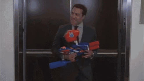 a man in a suit is holding an orange boxing glove .