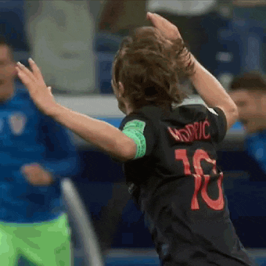 a soccer player wearing a black jersey with the number 10 on it is dancing .