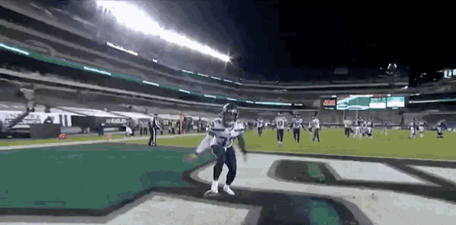 a football player with the number 27 on his jersey is running on a field