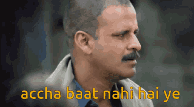 a man with a mustache and the words " accha baat nahi hai ye " behind him