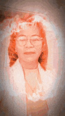 a woman with red hair wearing glasses and a white shirt