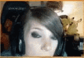 a close up of a woman 's face with a pikachu in the background