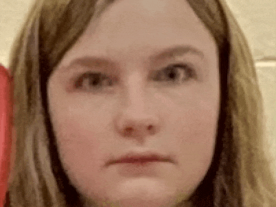 a close up of a woman 's face with a serious expression .