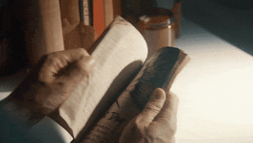 a person is reading a book with the word dog written on it