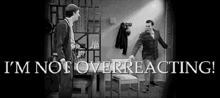 a black and white photo of two men with the words i 'm not overreacting behind them