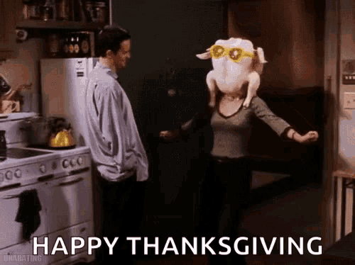 a man and a woman in a kitchen with a turkey on their head and the words happy thanksgiving