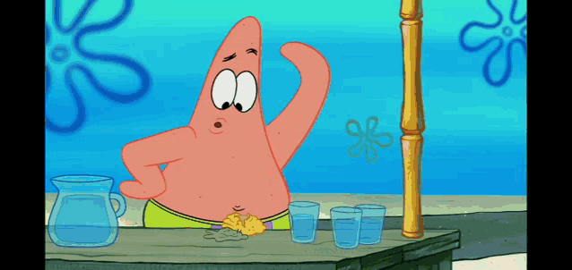 patrick star from spongebob squarepants is standing behind a table with glasses of water and a pitcher of water