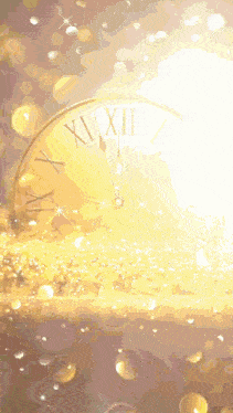 a gold clock with roman numerals xii and x on the face