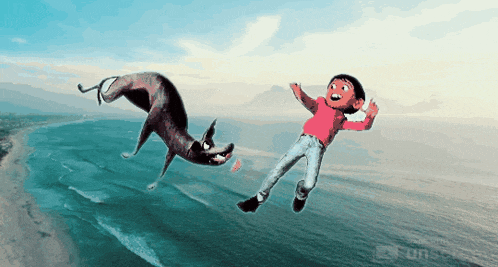 a boy and a dog are flying over the ocean