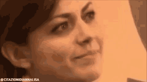 a close up of a woman 's face looking at the camera .