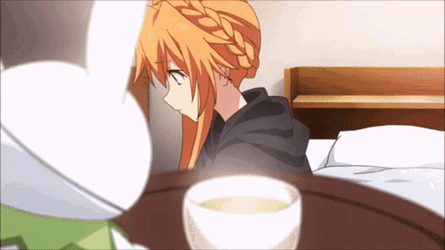 a girl sitting on a bed with a cup of tea on a tray