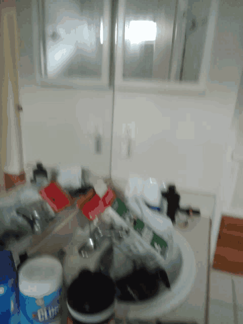 a bottle of clorox sits on a counter next to a sink
