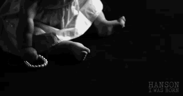 a black and white photo of a baby with the words hanson i was born written on the bottom