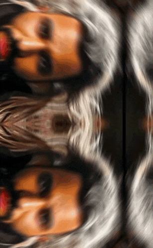 a blurred image of a woman 's face with a reflection of her face