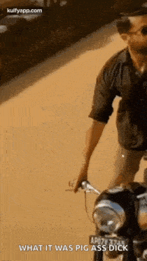 a man is riding a motorcycle down a road .