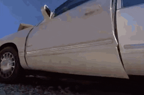 a white car with its door open and a piece of paper coming out of it .