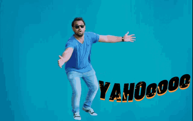 a man in a blue shirt and jeans is jumping in the air with the word yahoo on the bottom