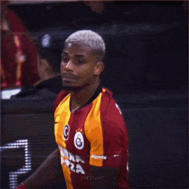 a soccer player with the number 4 on his jersey is running towards another player