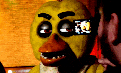 a person is taking a picture of a yellow duck