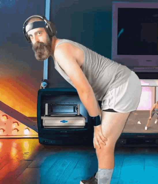 a man with a beard wearing a headband and headphones