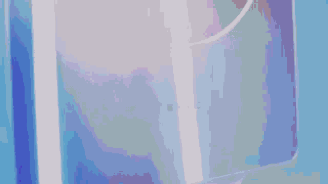 a woman in a white dress and purple necklace is dancing in a blue room .