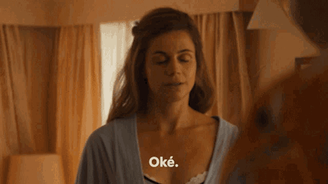 a woman with her eyes closed and the word oke on the bottom