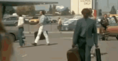 a blurry picture of people walking in front of a hilton hotel