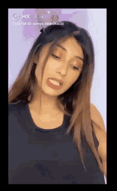 a woman is making a funny face with her mouth open .