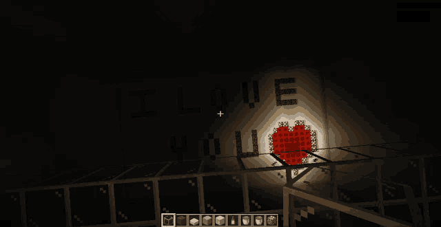 a sign that says i love you in a dark room