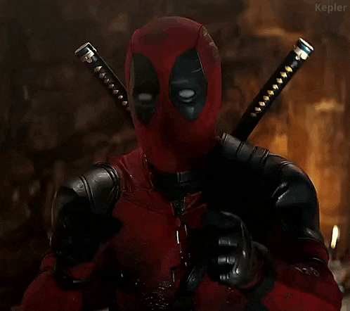 deadpool is pointing at the camera and saying `` let this man cook '' while holding a piece of food .