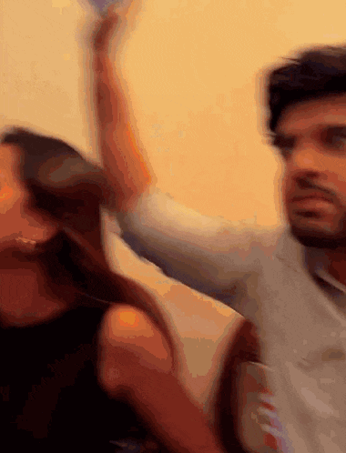 a man and a woman are dancing together in a blurry photo