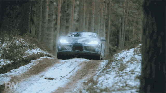 a car is driving down a snowy road with the letters rn on the bottom