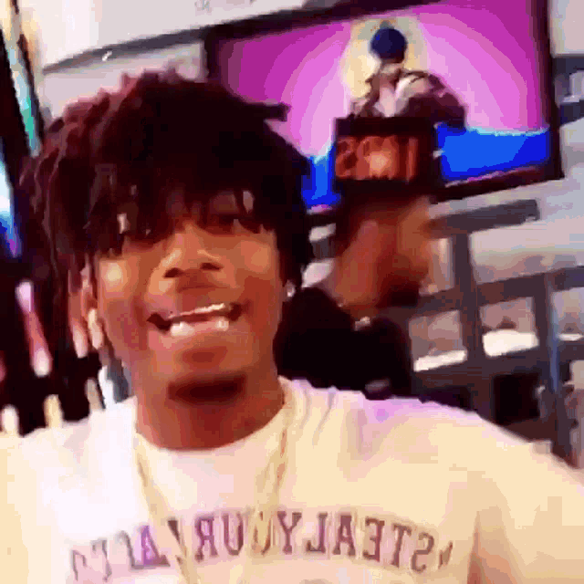 a man wearing a white shirt with the word ja3t2 on the front