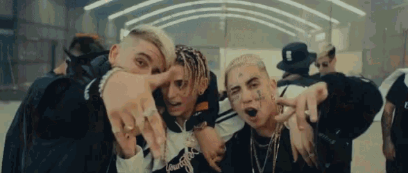 a group of young men are posing for a picture and one of them has a tattoo on his face that says s.